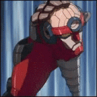 a robot is standing in front of a blue curtain with a drill in his hand .