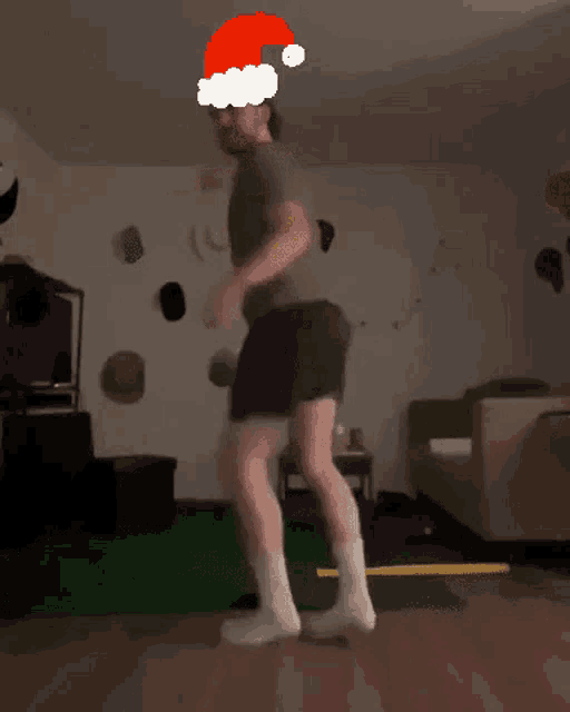 a man wearing a santa hat jumps in the air