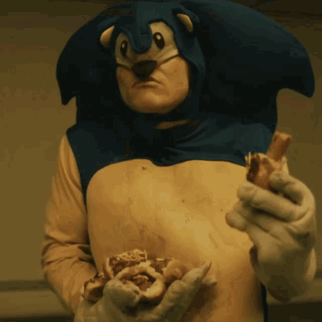 a man dressed as sonic the hedgehog is holding a piece of meat