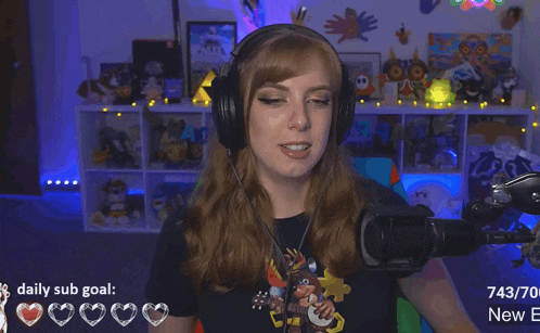 a woman wearing headphones stands in front of a microphone with a daily sub goal of 743/70