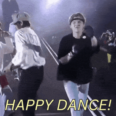 two men are dancing on a stage with the words happy dance written below them