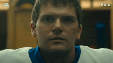 a close up of a man 's face with the hulu logo in the background