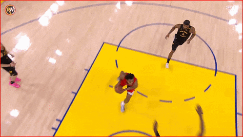 a basketball game is being played on a court with adobe advertisements