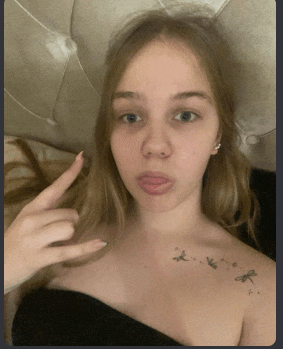 a girl with a tattoo on her shoulder is making a funny face