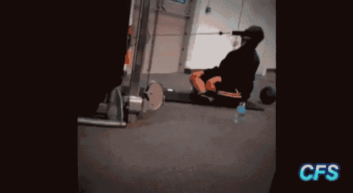 a man is sitting on the floor in a gym with a bottle of water and the word cfs on the bottom right