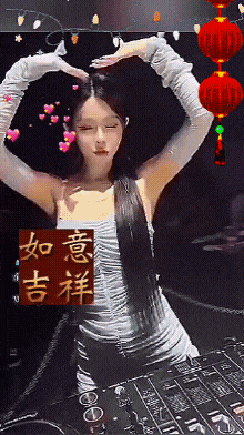 a woman making a heart shape with her hands in front of a chinese symbol
