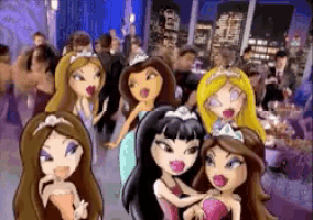a group of bratz dolls are standing next to each other