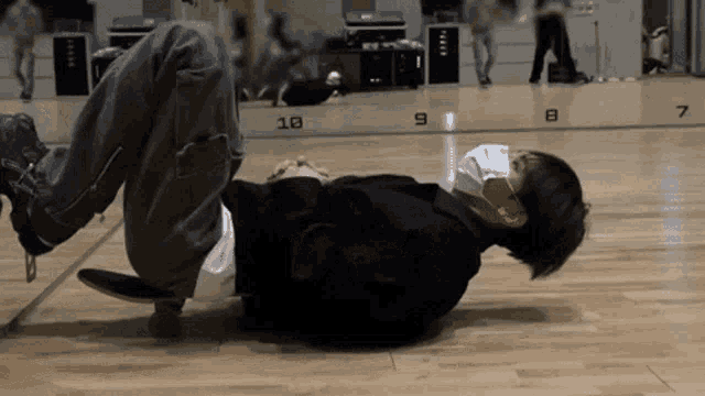 a man is laying on the floor wearing a mask and headphones