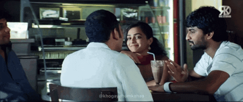 a group of people are sitting at a table with a watermark that says @k hogayhumikahaaa