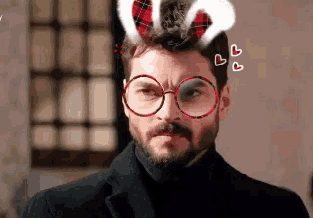 a man with a beard wearing glasses and bunny ears