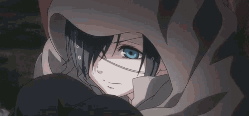 a close up of a person with blue eyes wearing a hood and a mask .