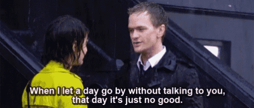 a man and a woman are standing next to each other in the rain and the man is talking to the woman