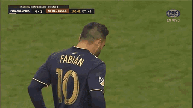 a soccer player with the number 10 on his back is celebrating