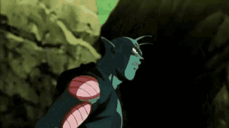 piccolo from dragon ball z is standing in front of a rock in the dark .