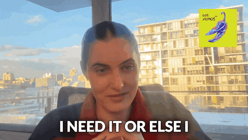 a woman with blue hair says i need it or else i in front of a building