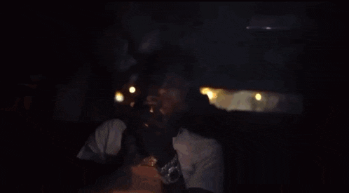 a man is smoking a cigarette in a car .
