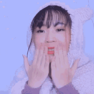 a close up of a woman wearing a hoodie with bunny ears .
