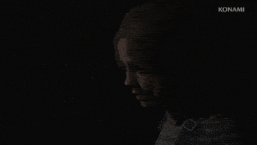 a young girl in a dark room with konami written in the corner