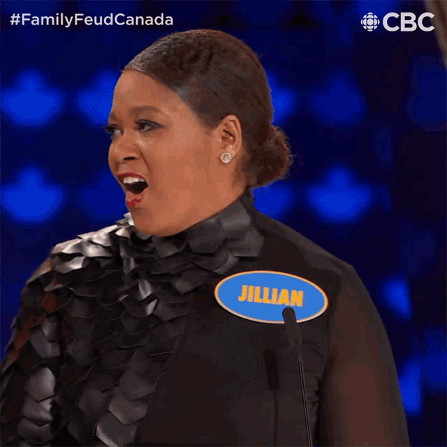 a woman stands in front of a microphone with a name tag that says jillian
