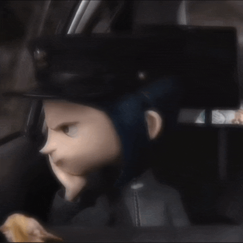 a doll with blue hair and a top hat is sitting in the back seat of a car