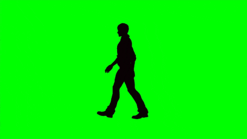it is a silhouette of a man walking on a green screen .