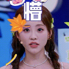 a woman with a flower in her hair is wearing a necklace and earrings .