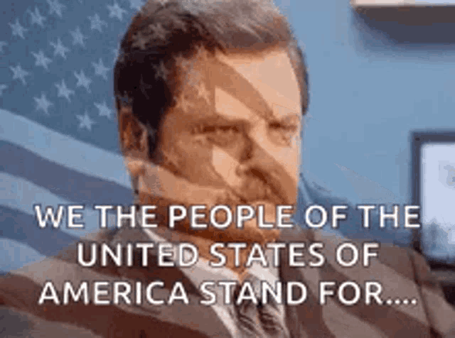 a man in a suit and tie is sitting in front of an american flag and a quote .