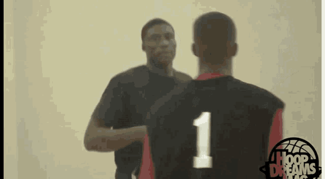 a basketball player with the number 1 on his jersey