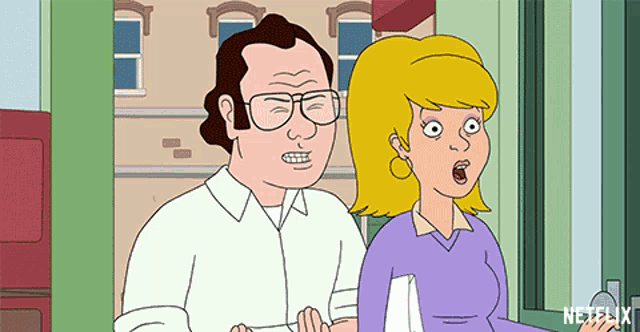a man and a woman are standing in front of a building .