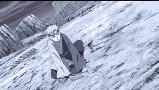 a man in a kimono is kneeling on the ground in a snowy field .