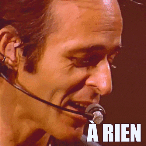 a close up of a man wearing a microphone with the word a rien in the background