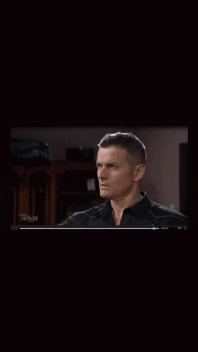 a man in a black shirt is being pointed at by another man