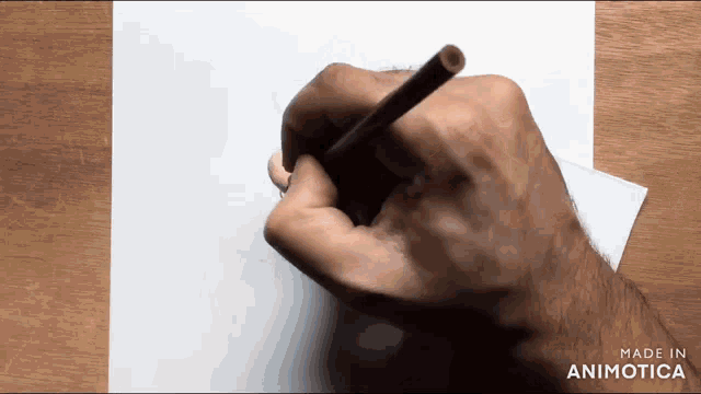 a hand is holding a pencil on a piece of paper with the words made in animotica below it