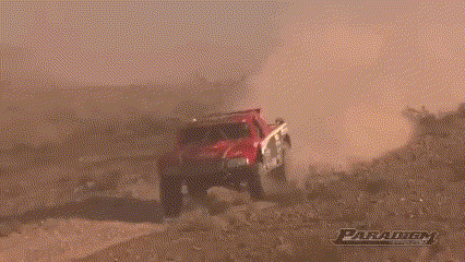 a red jeep is driving down a dirt road with a paratech logo in the background