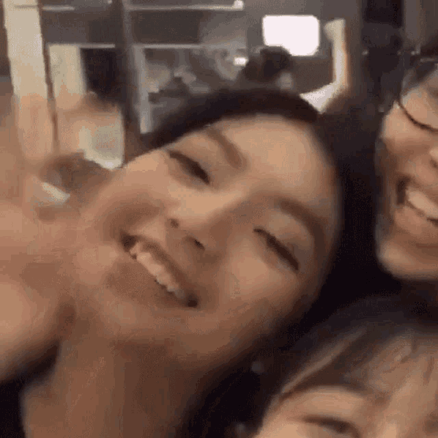 a group of young women are taking a picture of themselves and smiling .