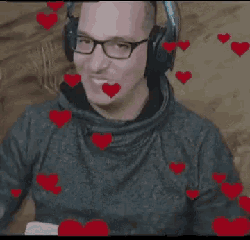 a man wearing headphones and glasses is surrounded by hearts
