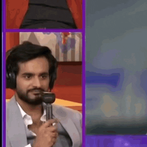 a man wearing headphones is holding a microphone in his mouth