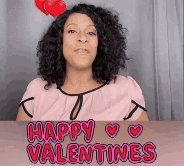 a woman says happy valentine 's with two hearts above her head