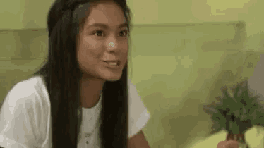 a young girl with long hair is sitting on a bed .