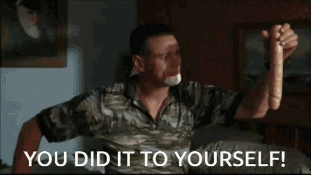 a man sitting on a couch with a snake in his hand and the words you did it to yourself below him