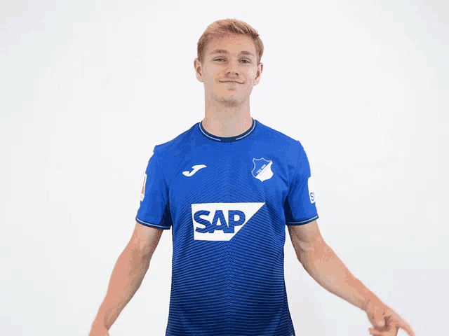 a man wearing a blue shirt with the word sap on the front