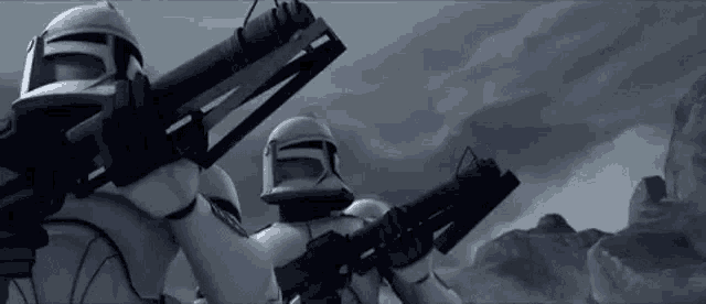 two clone trooper soldiers are standing next to each other holding guns in a black and white photo .