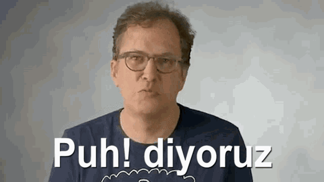 a man wearing glasses and a blue shirt says puh ! diyokuz
