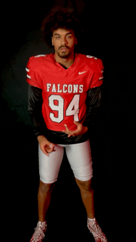 a man wearing a red jersey with the number 94 on it