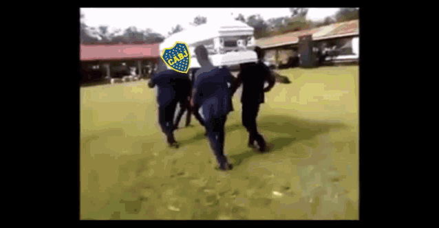 a group of men are carrying a coffin with a cabj logo on it .
