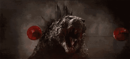 a close up of a monster with its mouth open and red apples coming out of it 's mouth .