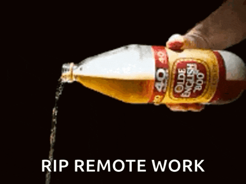 a person pouring a bottle of olde english 800 into a glass