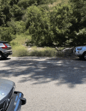 two cars are parked on the side of the road