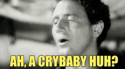 a black and white photo of a man with his eyes closed and the words `` ah , a crybaby huh ? '' .