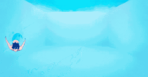 a dolphin is swimming in the water with bubbles